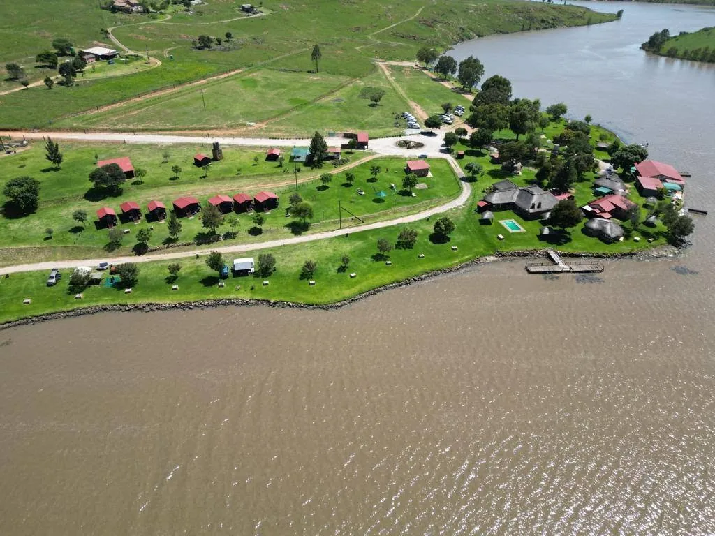 Aerial view of camping and fishing stands next to the water at Maanlig Oord